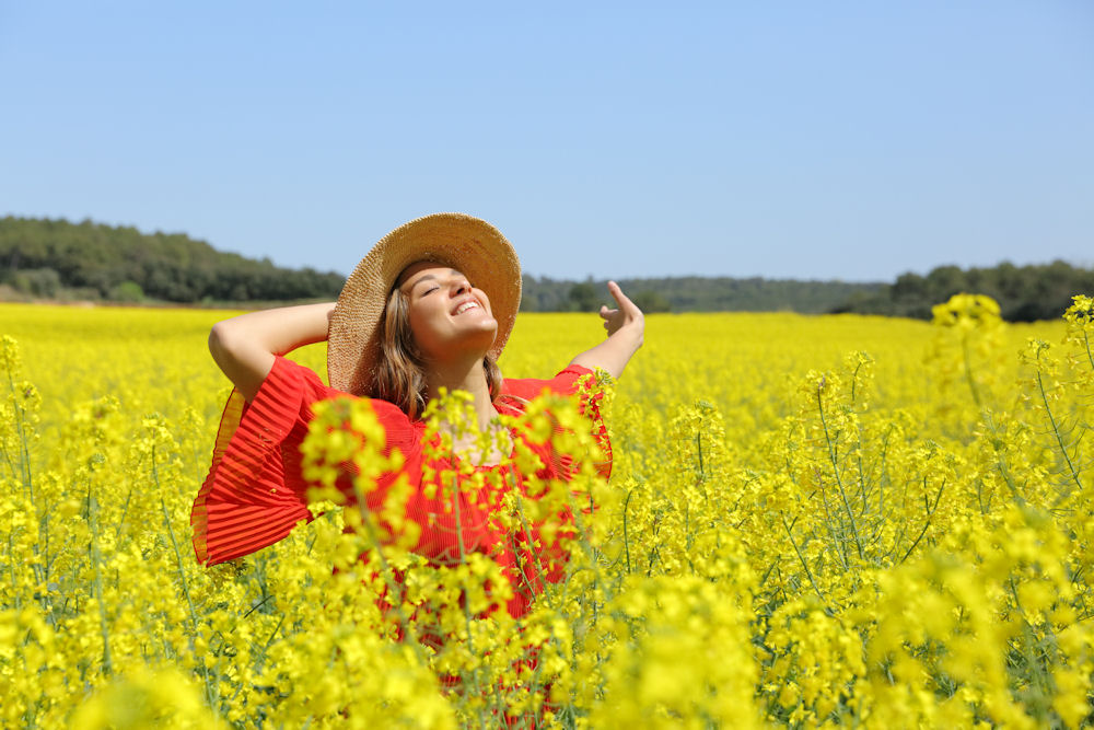 a-woman-happy-looking-up-in-a-field