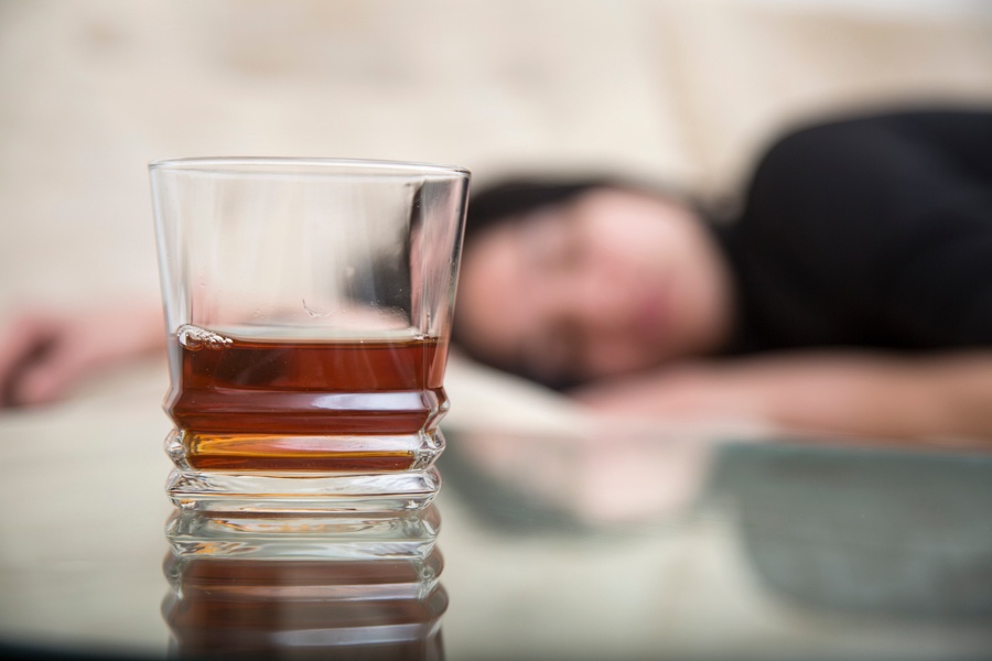 an alcoholic woman lying on a couch